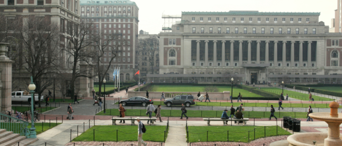 columbia during the day with students walking to class between impressive columned buildings